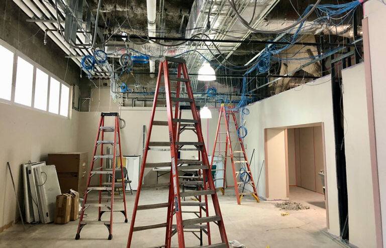 Pharmacy Ventilation installation process images of drop ceiling removed and ceiling cables being laid out