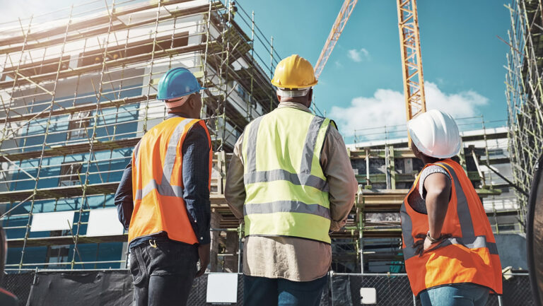 Construction workers looking a work site